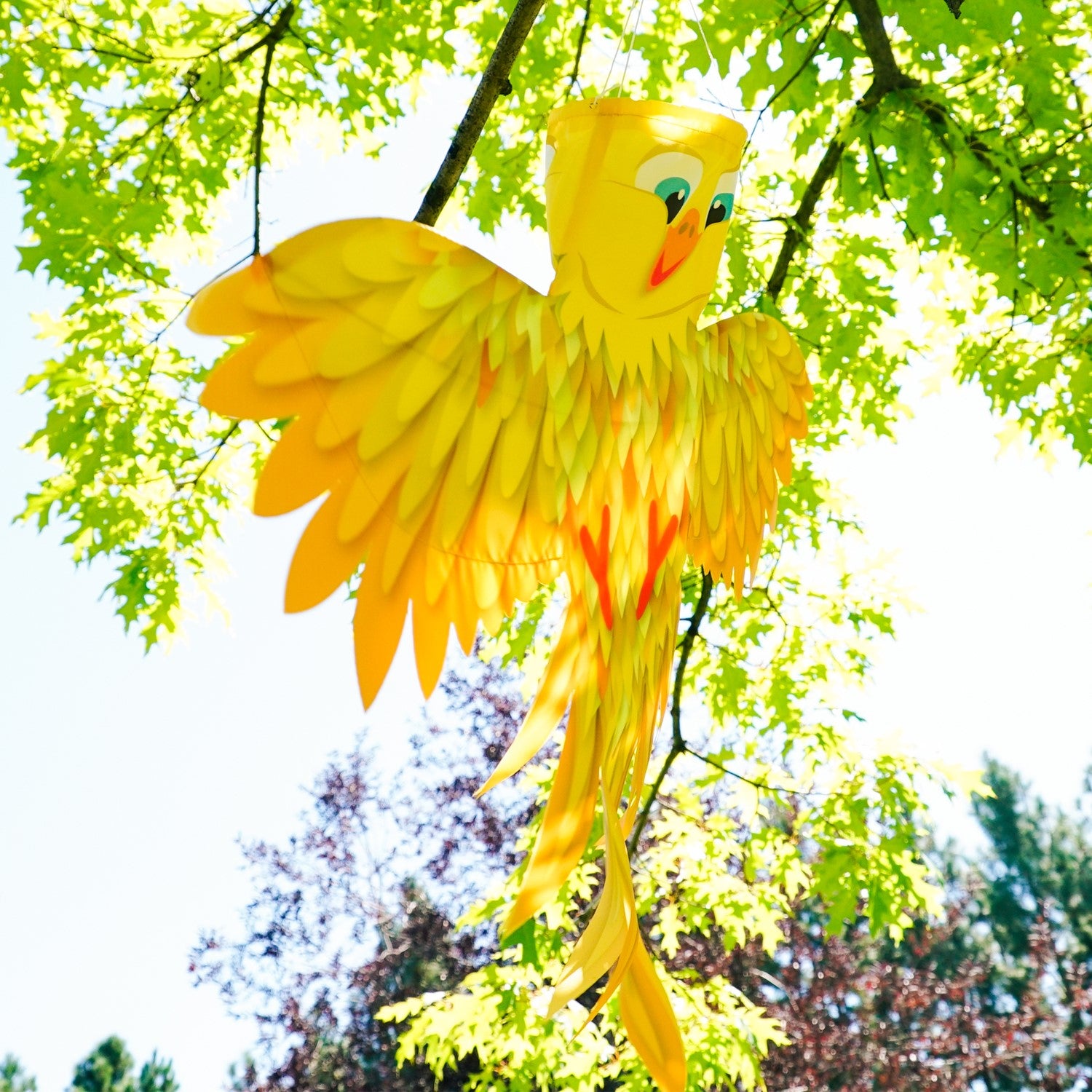 Yellow Bird Windsock in vibrant yellow with outstretched wings, designed for outdoor hanging, swaying beautifully in the breeze.