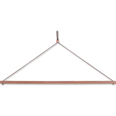 1/2 in. Wall Art Hanger made from natural hardwood with braided cord displayed in a stylish indoor setting.