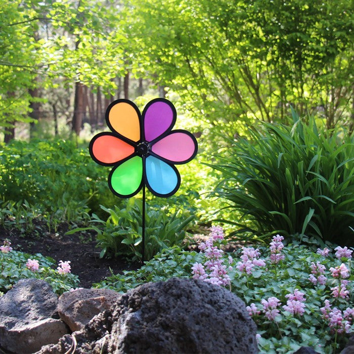 10-inch Neon Fusion Flower Spinner featuring a colorful flower wheel on a fiberglass pole, spinning in an outdoor garden setting.