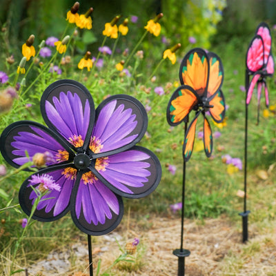 Assorted 10-inch realistic flower spinners showcasing Aster, Sunflower, and Peony designs, gently spinning in an outdoor garden setting.