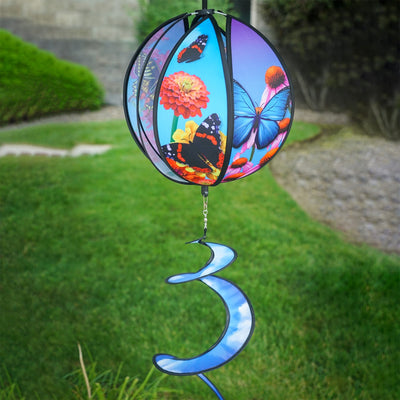 11-inch butterfly hanging ball spinner with six colorful butterfly design panels spinning in a garden setting on a sunny day.