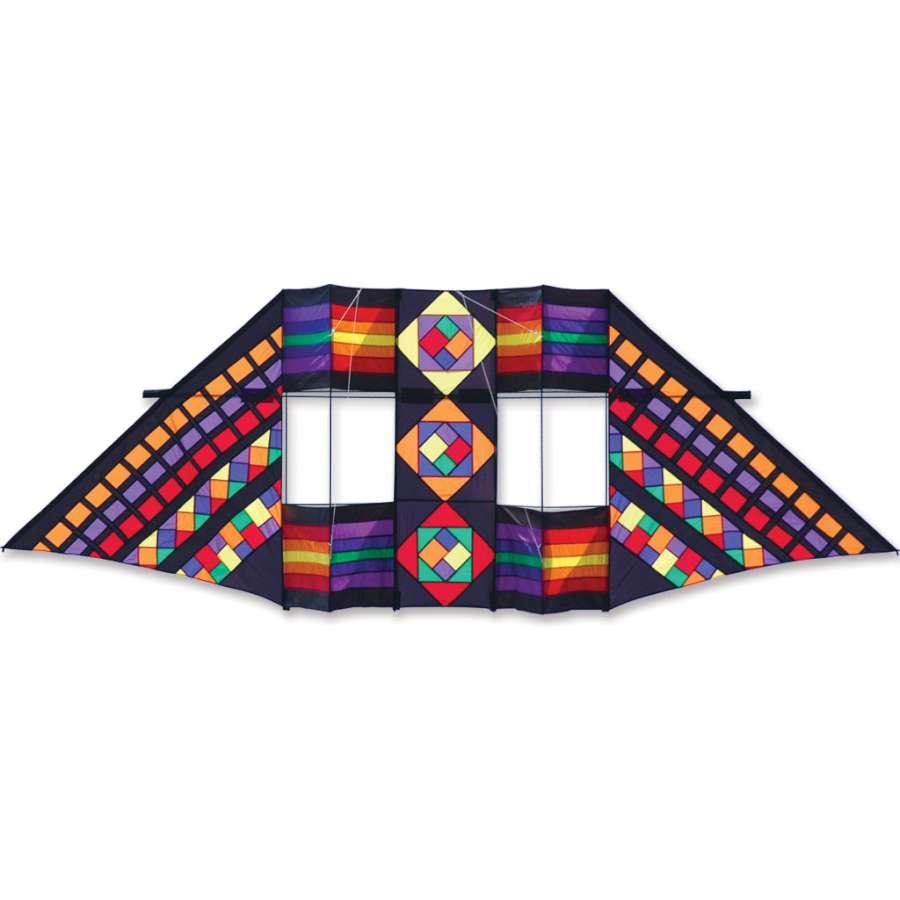 Vibrant 12.5 ft. Swept Wing Double Box Delta Kite in Mayan Rainbow pattern soaring high against a clear blue sky.
