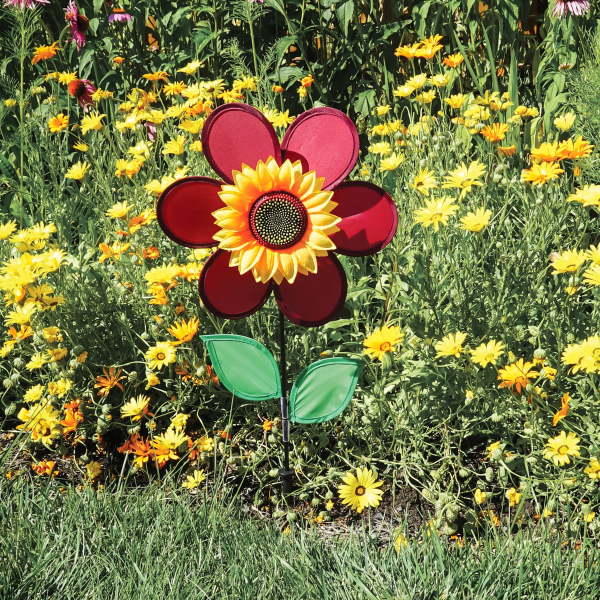 12" burgundy sunflower spinner in vibrant colors with spinning petals displayed in a garden setting, enhancing outdoor decor.