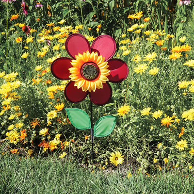12" burgundy sunflower spinner in vibrant colors with spinning petals displayed in a garden setting, enhancing outdoor decor.