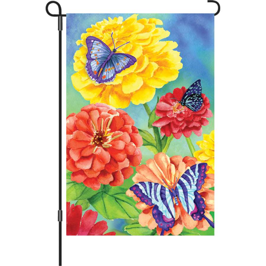 12 in. Butterfly garden flag with vibrant illumination and detailed butterfly design displayed in a flower bed, enhancing garden beauty.