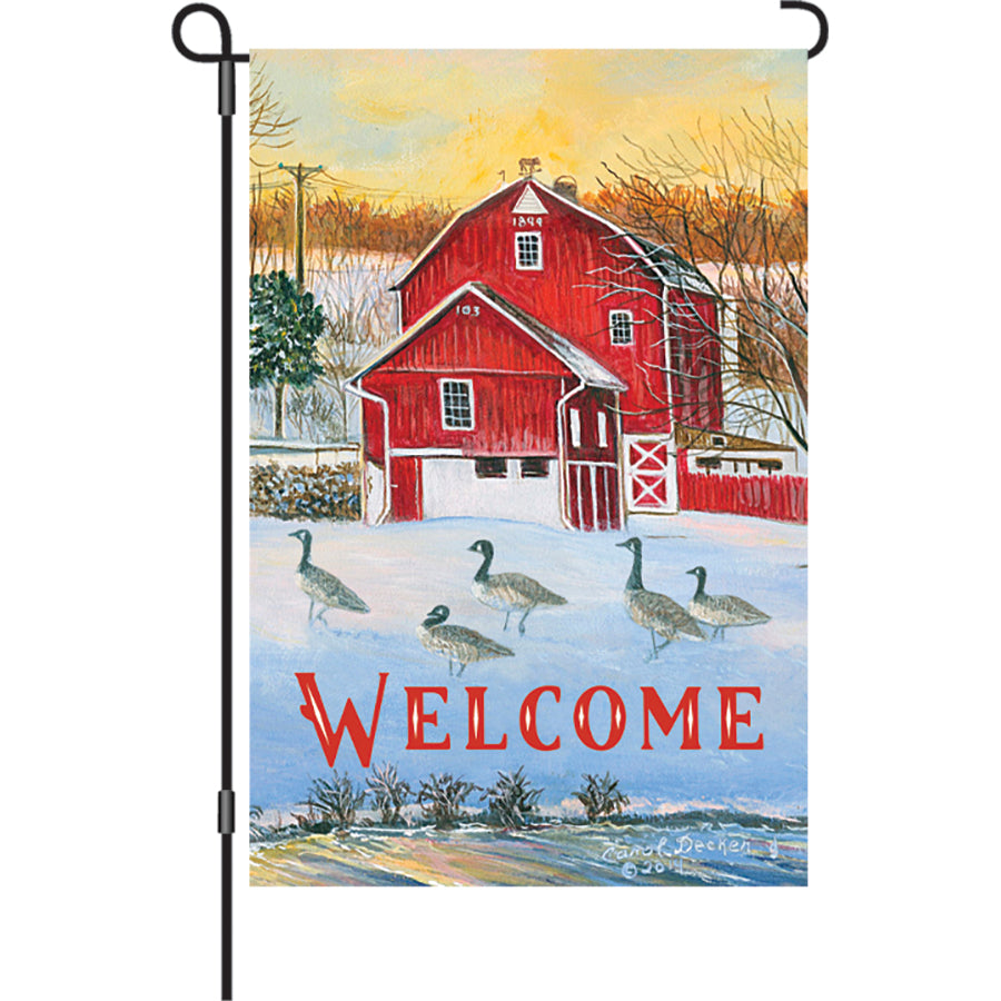 12 in. Country Barn flag displaying a 'WELCOME' message in vibrant colors, made with soft fabric, swaying in the garden.