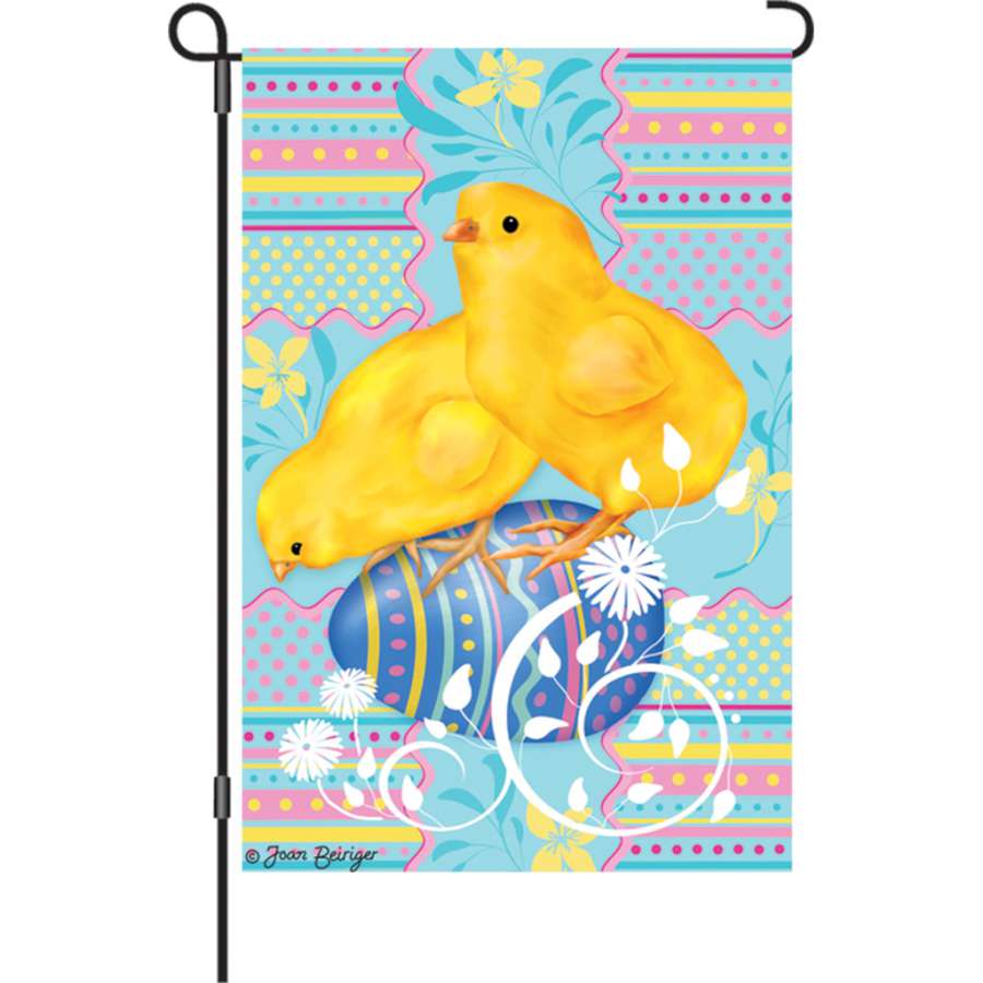 12 in. Easter Chicks garden flag featuring colorful illuminated chicks and eggs, displayed outdoors in a vibrant spring garden setting.