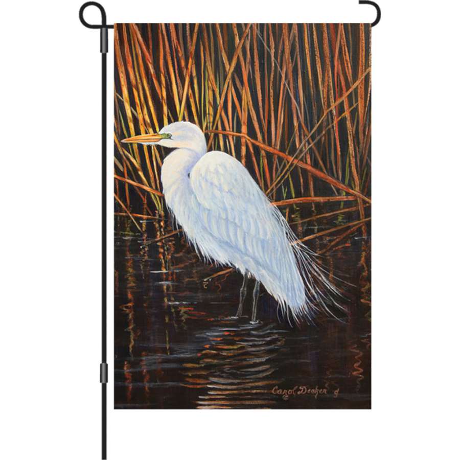 Illuminated 12 in. Egret garden flag displaying a vibrant egret design set against a colorful background in an outdoor setting.