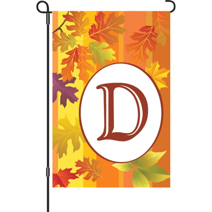 12 in. Fall Monogram Flag featuring a large initial 'D' against a backdrop of fall leaves and pumpkins, displayed on a garden flagstand.