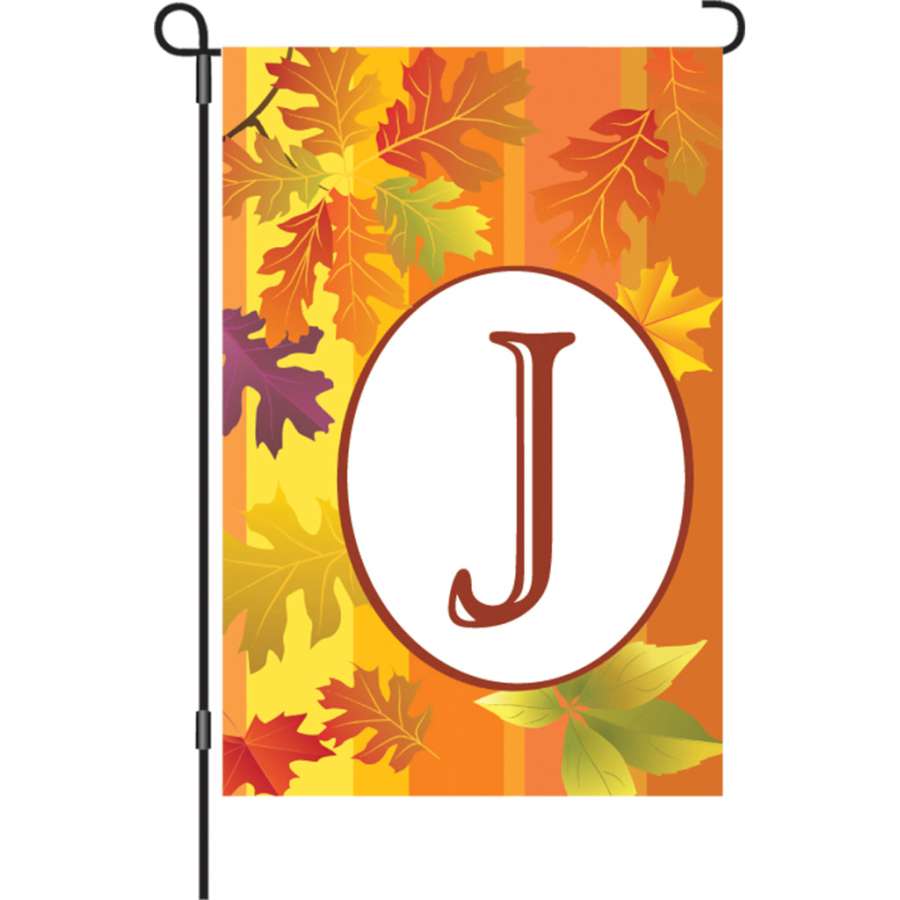 12 in. Fall Monogram Flag - J with vibrant autumn colors and personalized initial displayed outdoors in a garden setting.
