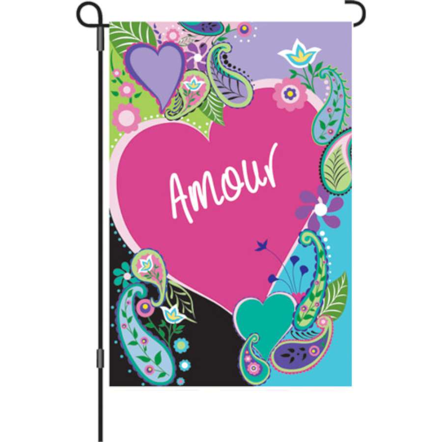 12 in. Flag - Amour showcasing a colorful spring design, displayed in a garden setting with flowers in bloom.