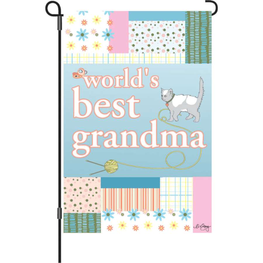 12 in. Flag - Best Grandma displayed in a garden, featuring colorful text and top-stitch detailing against a bright background.