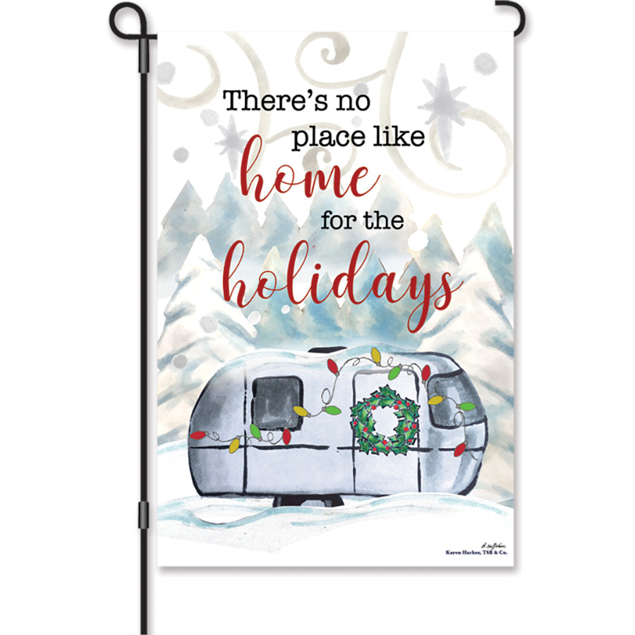 12 in. Christmas Camper flag featuring 'There's no place like home for the holidays' design, displayed in a garden setting with festive colors.