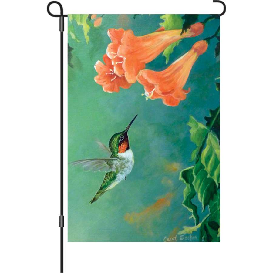 A 12 in. garden flag showcasing vibrant hummingbirds and trumpet vines, fluttering in a gentle breeze against a sunny backdrop.