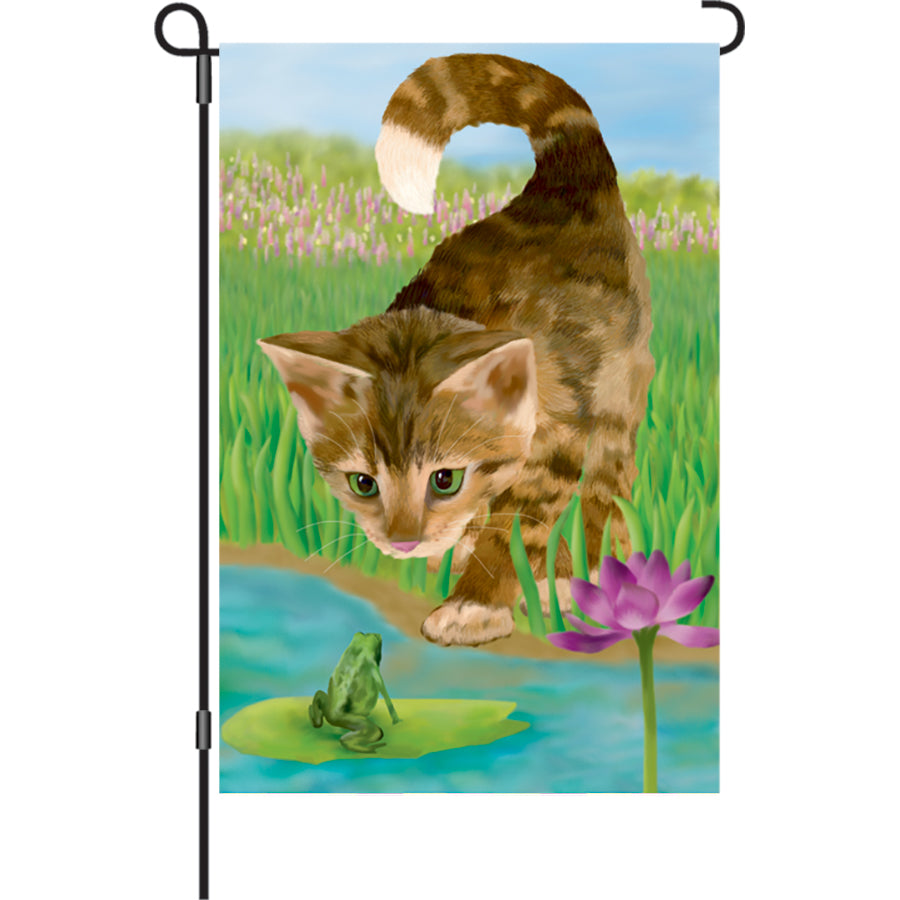 12 in. Flag - Nice to Meet You illuminated garden flag with colorful cat designs displayed in a flower bed for a cheerful outdoor look.