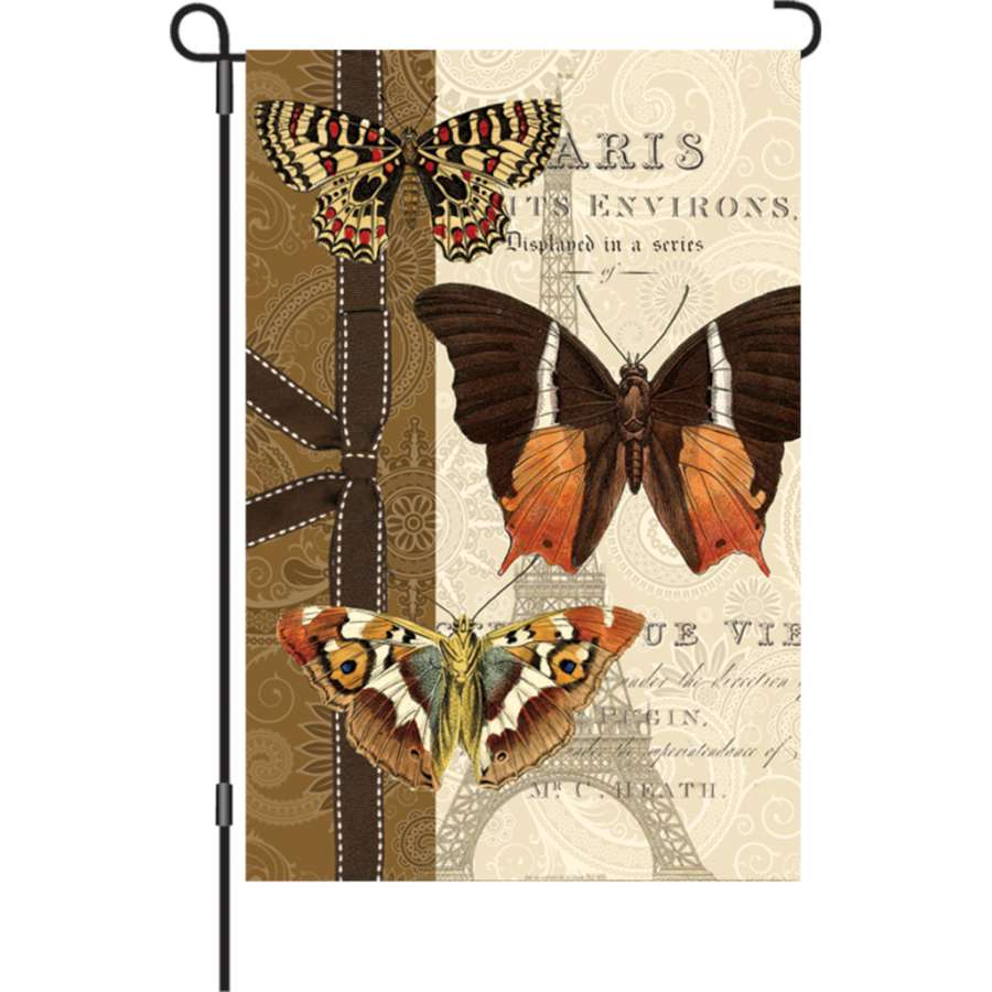 12 in. garden flag featuring a colorful Parisian Pappillon butterfly design displayed outdoors in a garden setting.