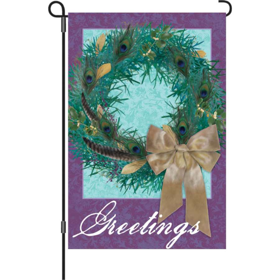 12 in. garden flag featuring a vibrant peacock wreath design, displayed outdoors, adding colorful seasonal charm to a yard setting.