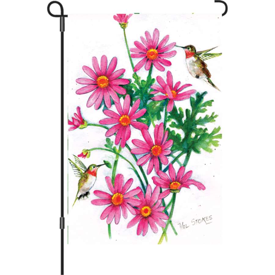 12 in. Flag - Pink Daisies featuring illuminated flowers displayed in a garden setting, showcasing bright pink daisies against a colorful background.