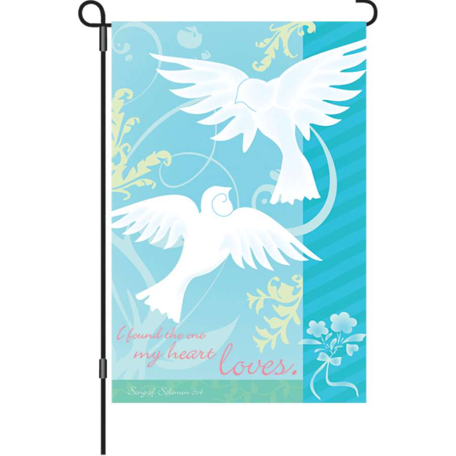 12 In Flag - The One I Love displayed in a garden setting, showcasing a colorful design of hearts and affectionate phrases in vibrant colors.