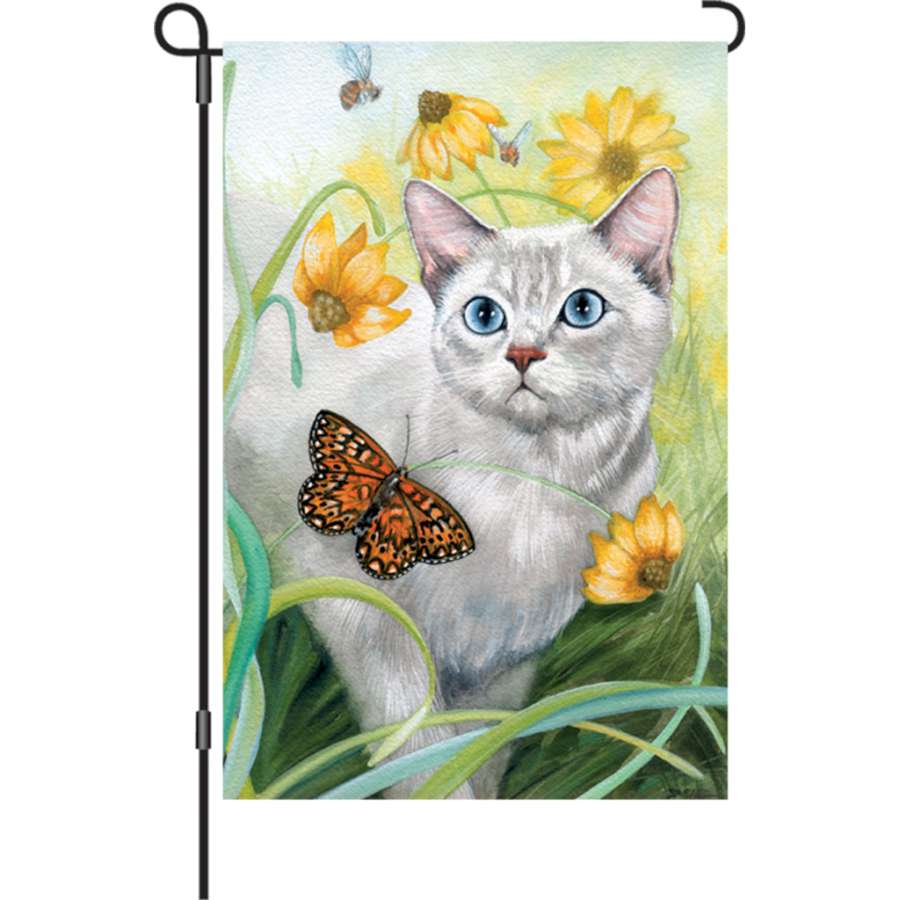 12 inch garden flag - The Wanderer featuring whimsical cats in vibrant colors displayed outdoors, illuminating the garden with charm.