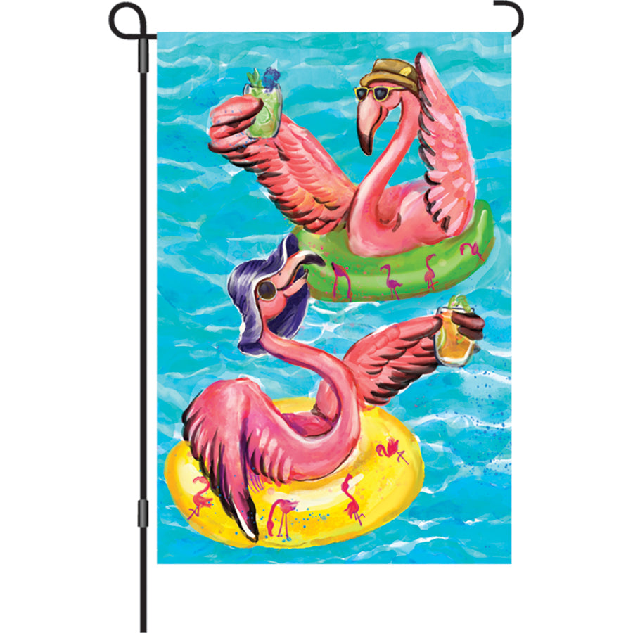 12 in. Flag - Poolside Flamingos, a colorful flamingo garden flag displayed poolside, radiating summer vibes.