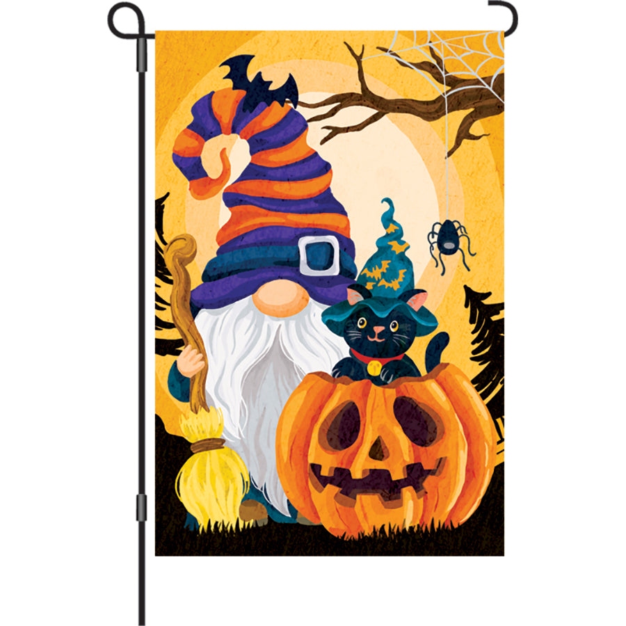 12 in. garden flag depicting a cheerful Halloween gnome with a pumpkin, illuminated for night display in a festive outdoor setting.