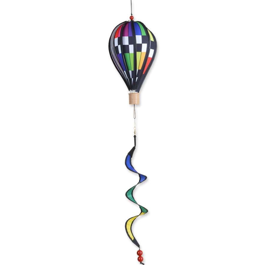 12 in. hot air balloon with a colorful checkered rainbow pattern, spinning gently in a garden setting on a sunny day.