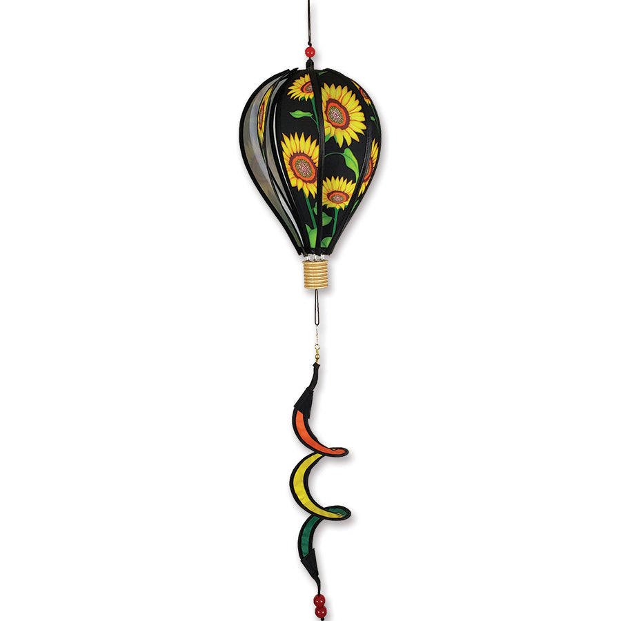 12 in. Hot Air Balloon featuring a vibrant sunflower design spinning gently in an outdoor garden setting, showcasing its whimsical charm.