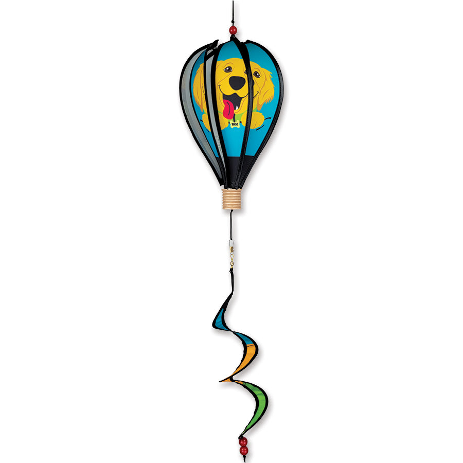 12 in. Hot Air Balloon depicting Wagz Golden Retriever design, displayed in a garden or festive setting with colorful accents.