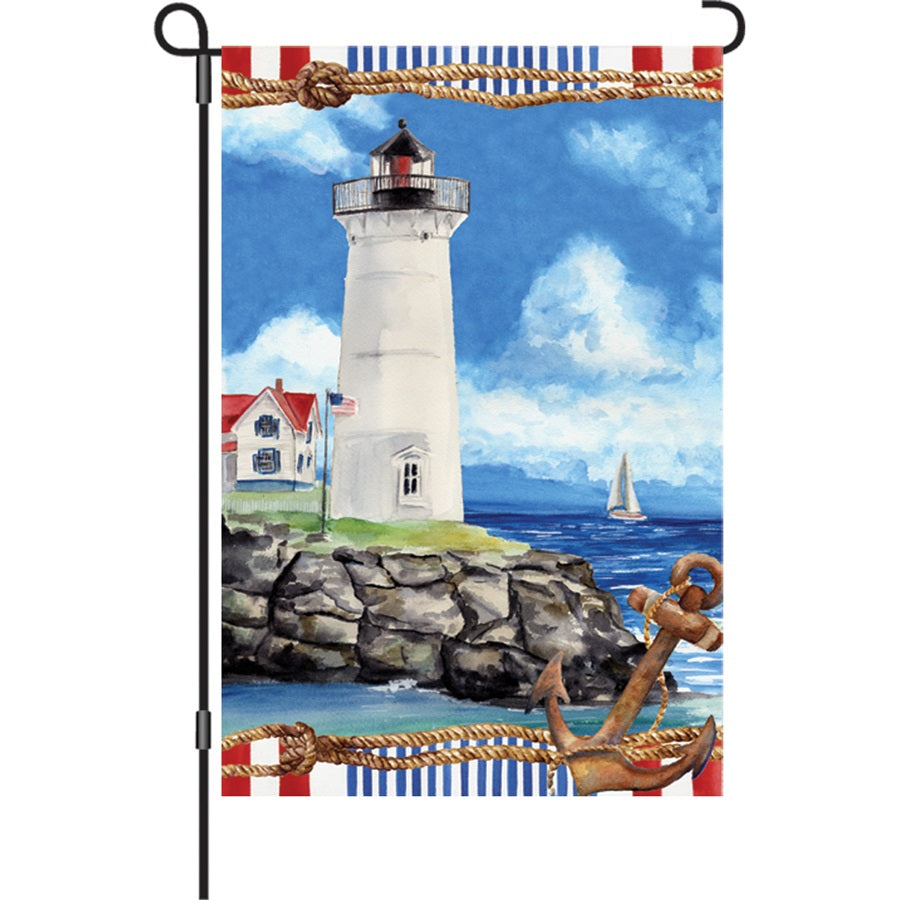 Vibrant 12 in. Nautical Lighthouse garden flag displayed in an outdoor setting, featuring a colorful lighthouse design on durable fabric.