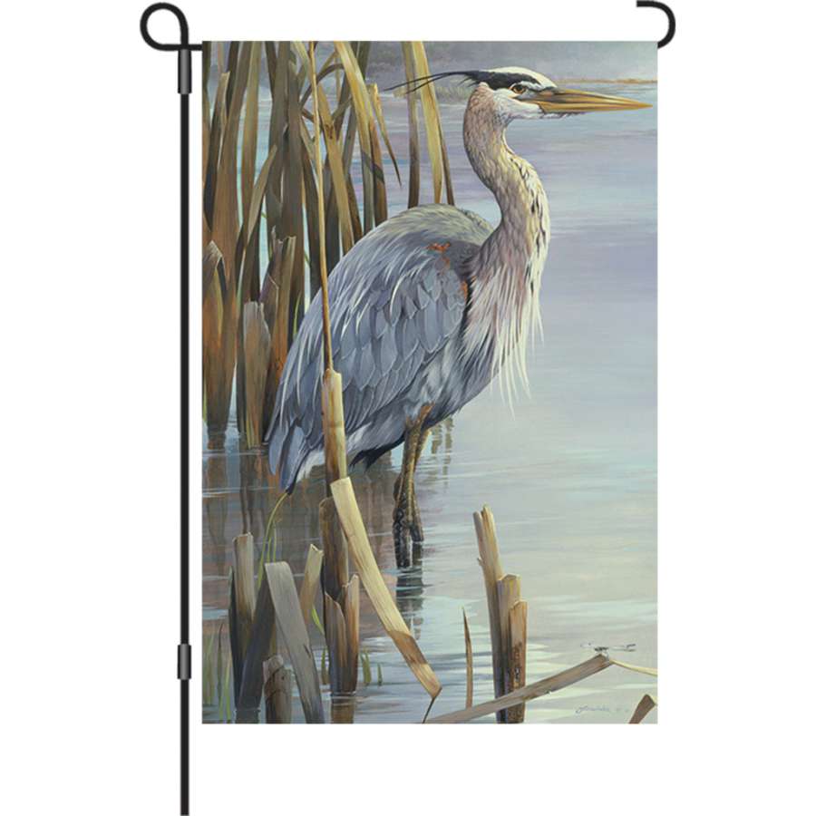 12 inch Peaceful Heron garden flag with illuminated design displayed in a serene garden setting during the evening.