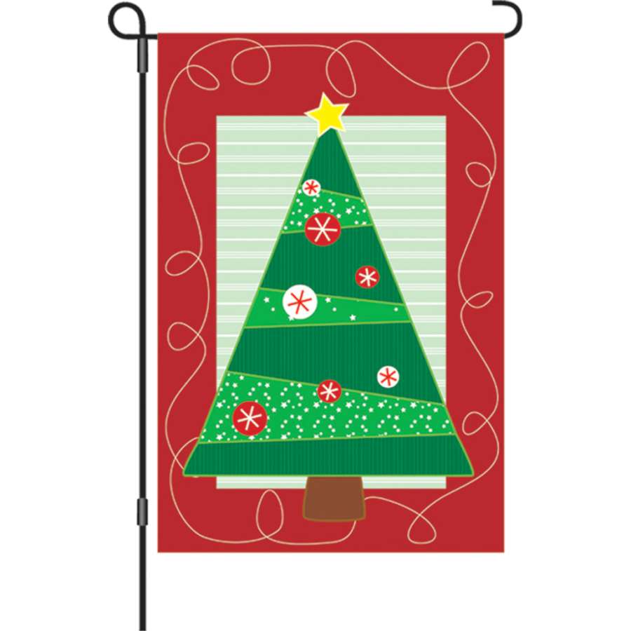 Soho Christmas garden flag displaying colorful holiday motifs, bright and festive, positioned in a garden setting during winter.