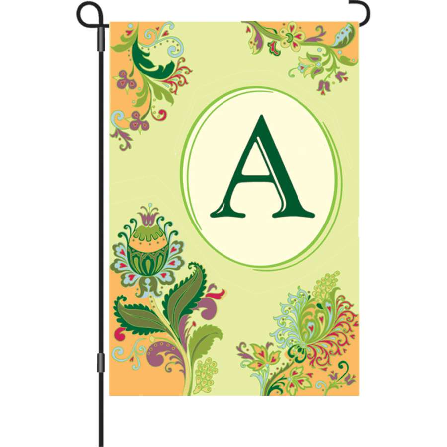 12 in. Spring Monogram Flag - A displayed in a garden, showcasing a vibrant monogram design against a colorful background.