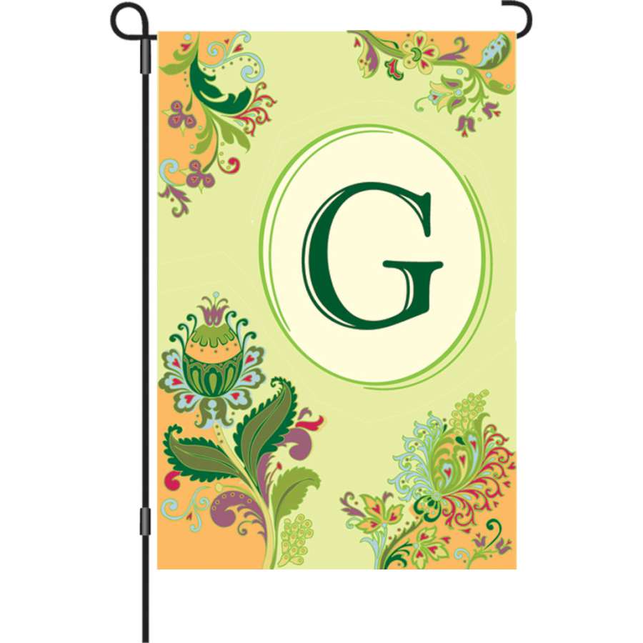 12 in. Spring Monogram Flag - G displayed in a garden setting featuring a vibrant spring design and the letter 'G'.