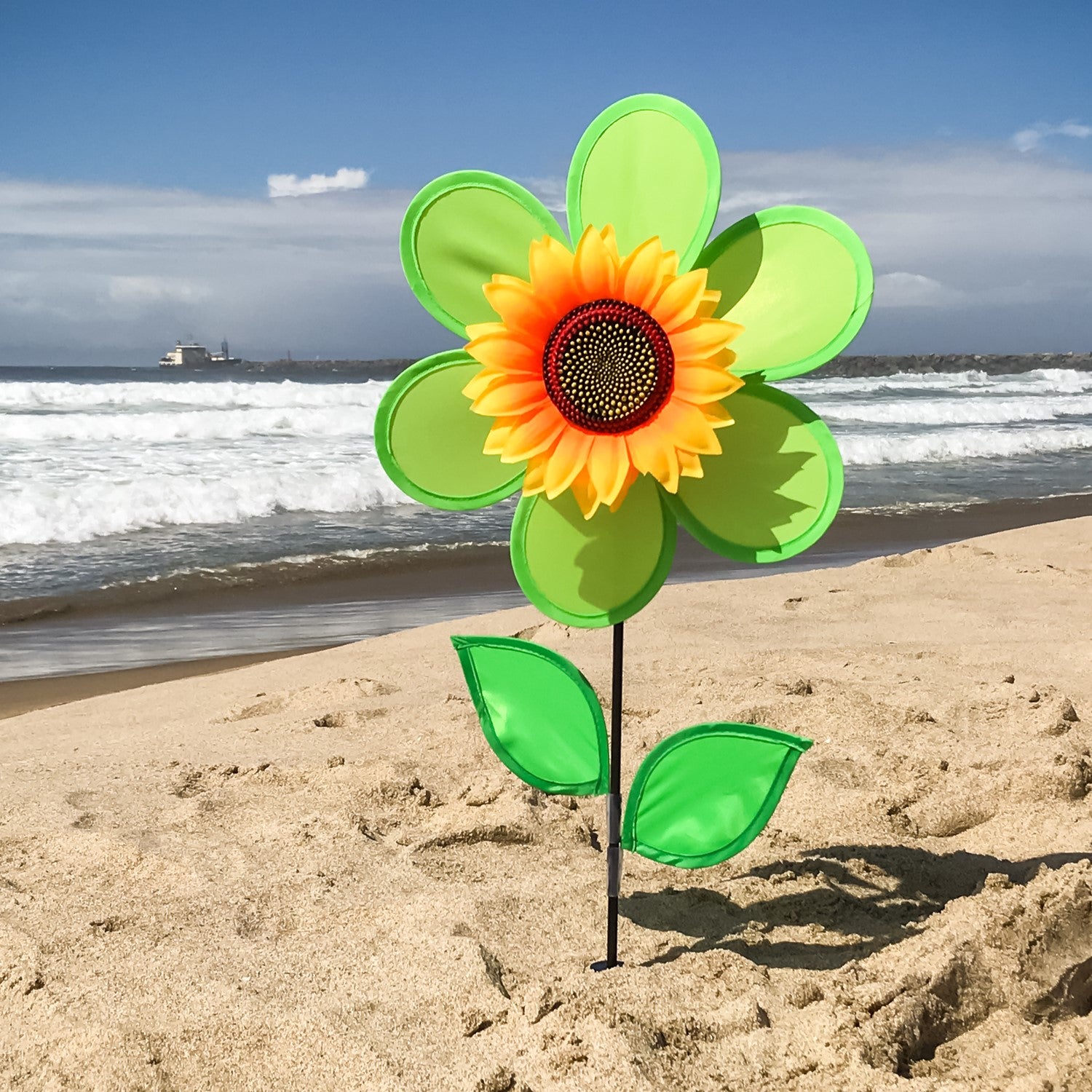12-Inch Green Sunflower Spinner with vibrant green petals and detailed sunflower center, elegantly displayed in a garden setting.