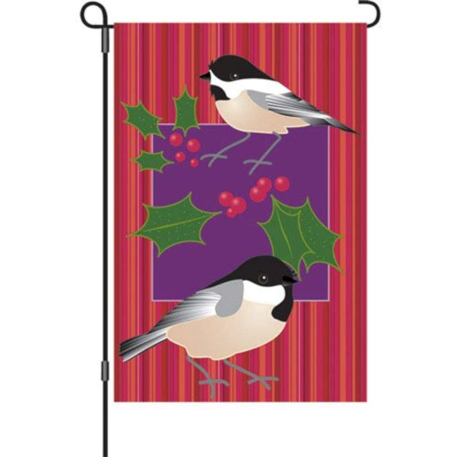 12-inch Holiday garden flag featuring cheerful winter designs displayed on a decorative stand in a snowy outdoor setting.