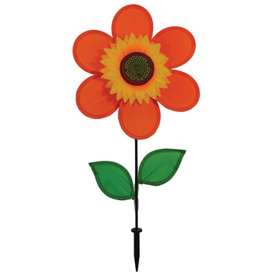 12-inch orange sunflower spinner with bright petals and green leaves, spinning on a sturdy fiberglass pole in a garden setting.