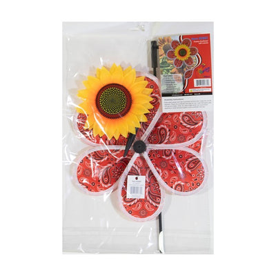 12-inch Paisley Sunflower Spinner with six colorful petals and detailed sunflower center, spinning gently in an outdoor garden setting.