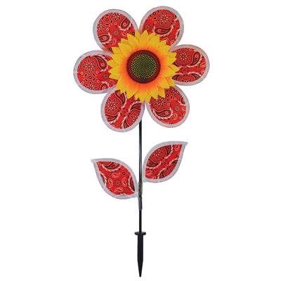 12-inch Paisley Sunflower Spinner with six colorful petals and detailed sunflower center, spinning gently in an outdoor garden setting.