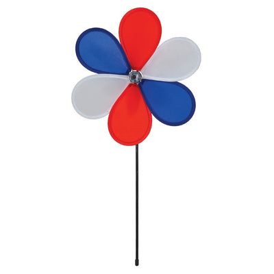 12-inch Patriot Flower spinner with red, white, and blue petals spinning on a 17-inch fiberglass pole in a garden setting.