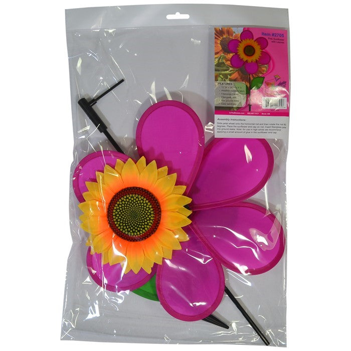 12-inch pink sunflower spinner featuring vibrant petals and realistic center displayed in a garden setting with a fiberglass pole.