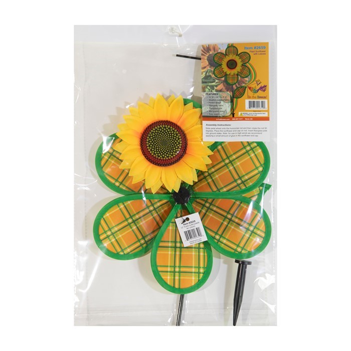 12 inches Plaid Sunflower Spinner with orange and green plaid petals rotating on a 17-inch fiberglass pole in a garden setting.