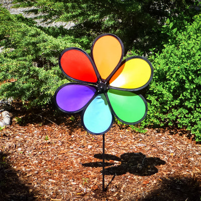 12-inch Rainbow Dazy Petal Spinner featuring six colorful petals, displayed in a garden, showcasing vibrant colors spinning in the breeze.