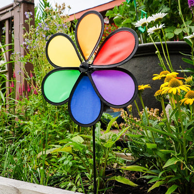 12-inch Rainbow Dazy Petal Spinner featuring six colorful petals, displayed in a garden, showcasing vibrant colors spinning in the breeze.