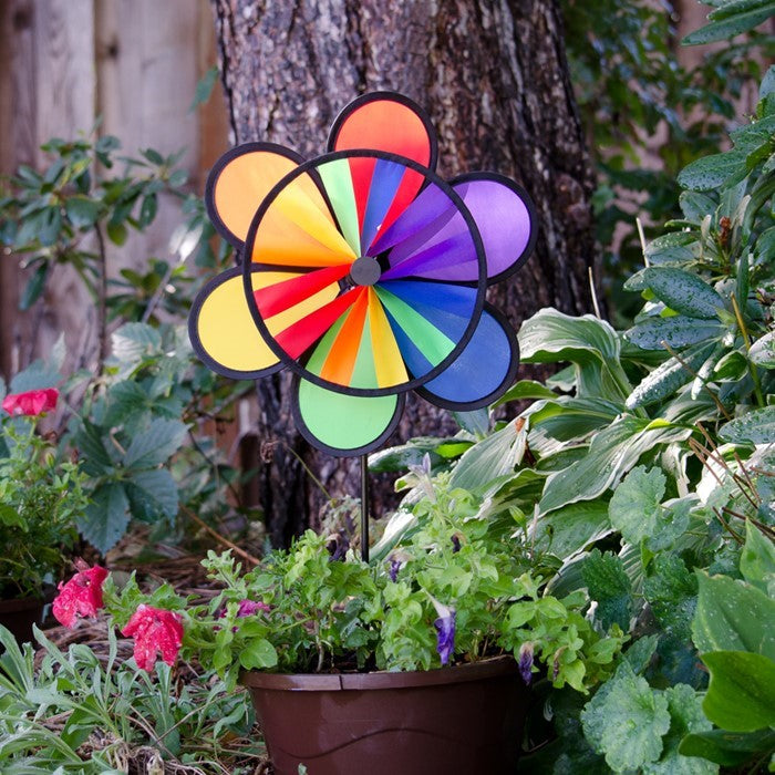 12-inch Rainbow Double Flower Wheel Combo wind spinner with vibrant colors, spinning gracefully in an outdoor garden setting.
