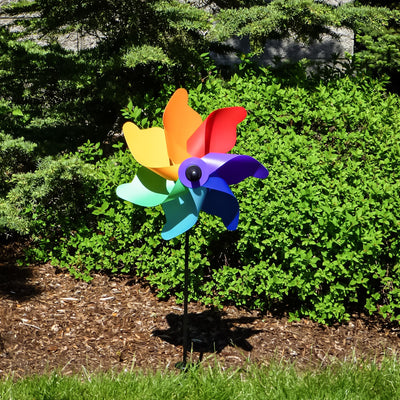 Colorful 12-inch Rainbow Poly Petal Spinner featuring bright petals on a fiberglass pole, spinning pleasantly in a garden setting.