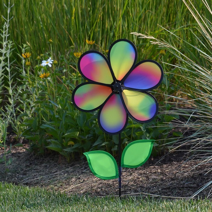 12-inch Jewel Flower spinner with colorful petals and leaves attached to a sturdy fiberglass pole, twirling beautifully in a garden setting.