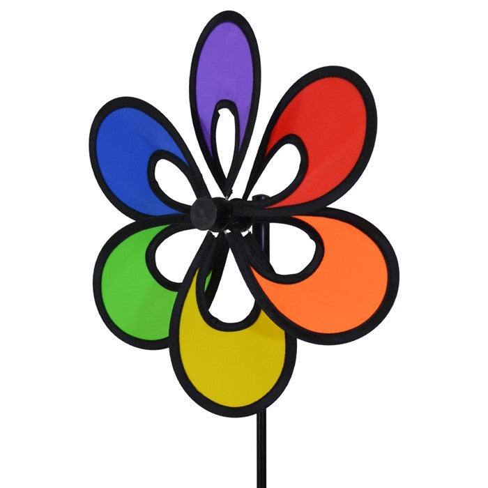Colorful 12" Rainbow Windee Wheelz Spinner with petal design, set against a bright blue sky in a garden setting, showcasing its vibrant hues.