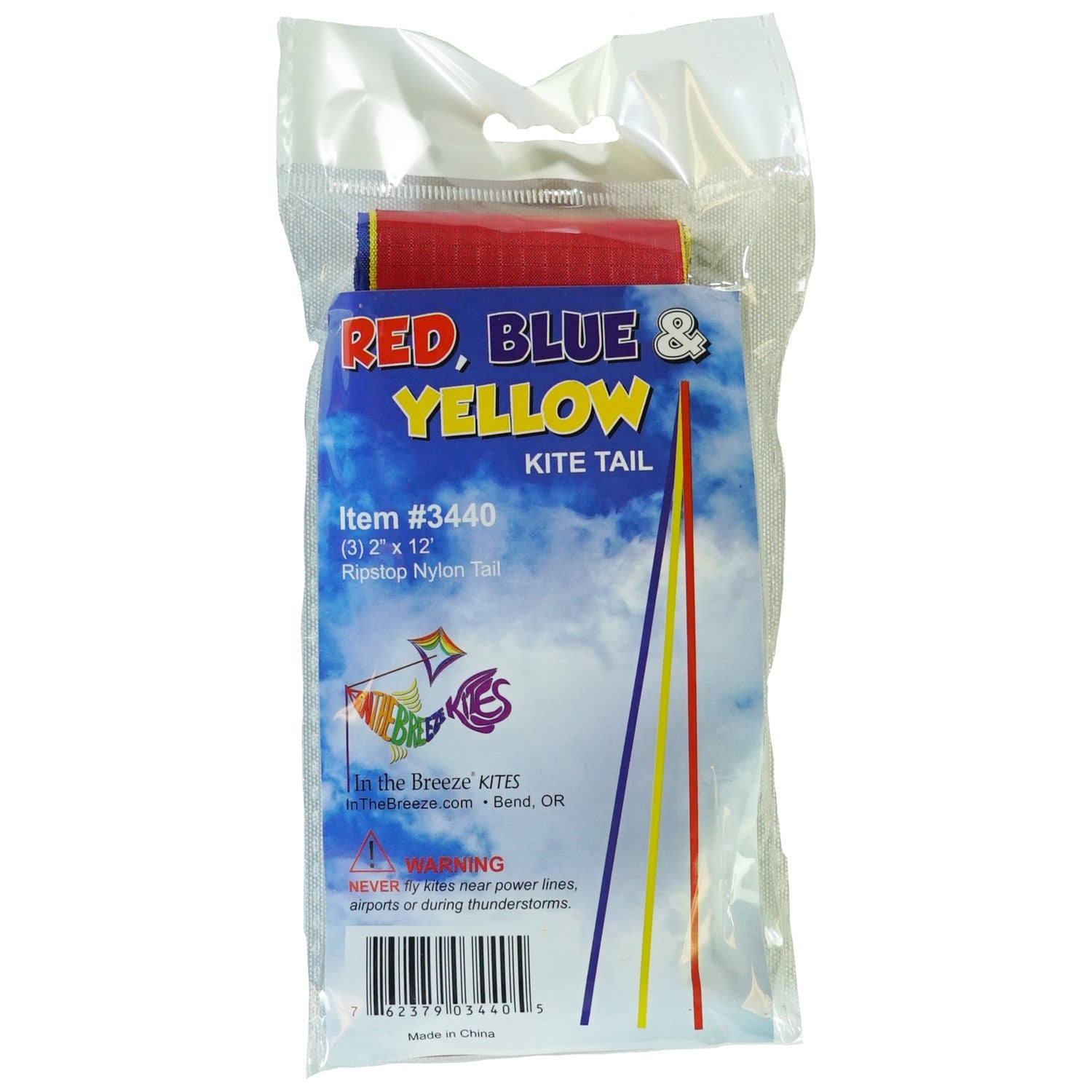 12' Red, Yellow & Blue Kite Tail made of ripstop fabric fluttering in the wind during a bright day, showcasing vibrant primary colors.