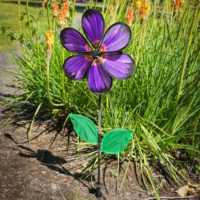 13.5-inch Aster Spinner with vibrant petals and green leaves, showcasing realistic flower design in an outdoor garden setting.